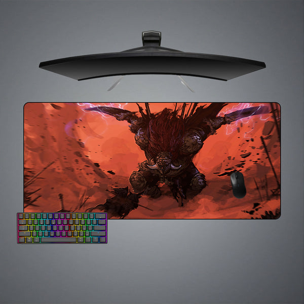 Gaming desk setup with a large mouse pad featuring an Elden Ring Radahn design, keyboard, and monitor on a gray background.