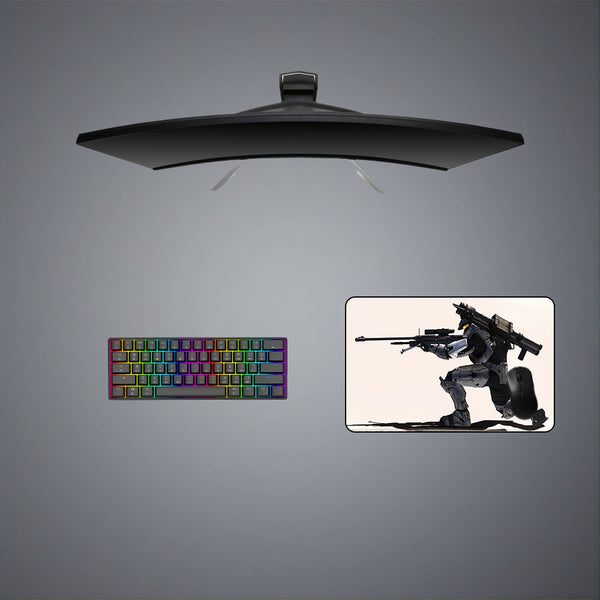 Gaming desk setup with a medium size mouse pad featuring a Halo Sniper design, keyboard, and monitor on a gray background.