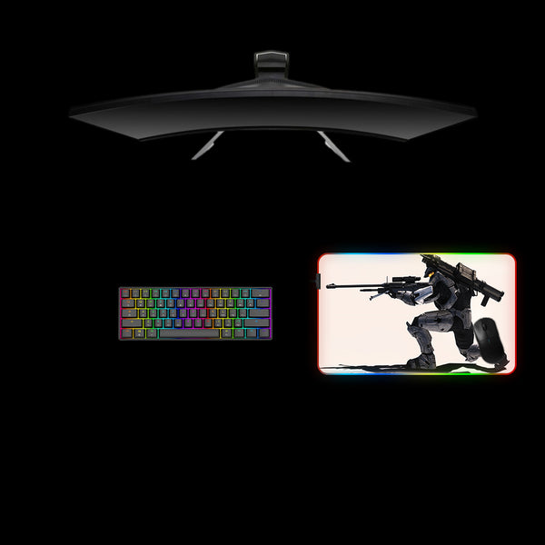 Gaming desk setup with an medium size RGB lit mouse pad featuring a Halo Sniper design, keyboard, and monitor.